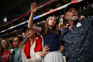 People react as they attend a memorial service for slain conservative commentator Charlie Kirk at State Farm Stadium, in Glendale, Arizona, U.S., 21 September 2025. REUTERS/Callaghan O'Hare